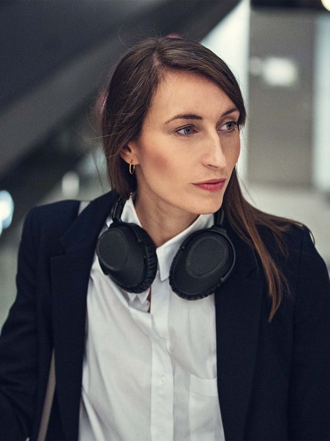 adapt-600---woman-on-the-go-with-headset-around-neck